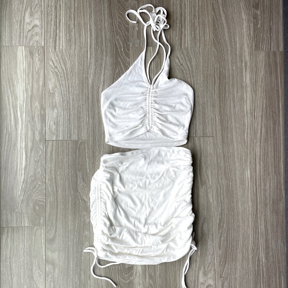Two piece halter top with adjustable scrunch on the sides of the skirt & top